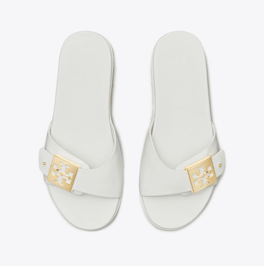 TORY BURCH MELLOW BUCKLE WHITE GOLD SLIDE SHOES | Shop now at Main &amp; Taylor Shoes!